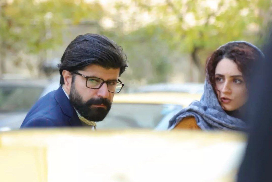 Two characters outside in a film still