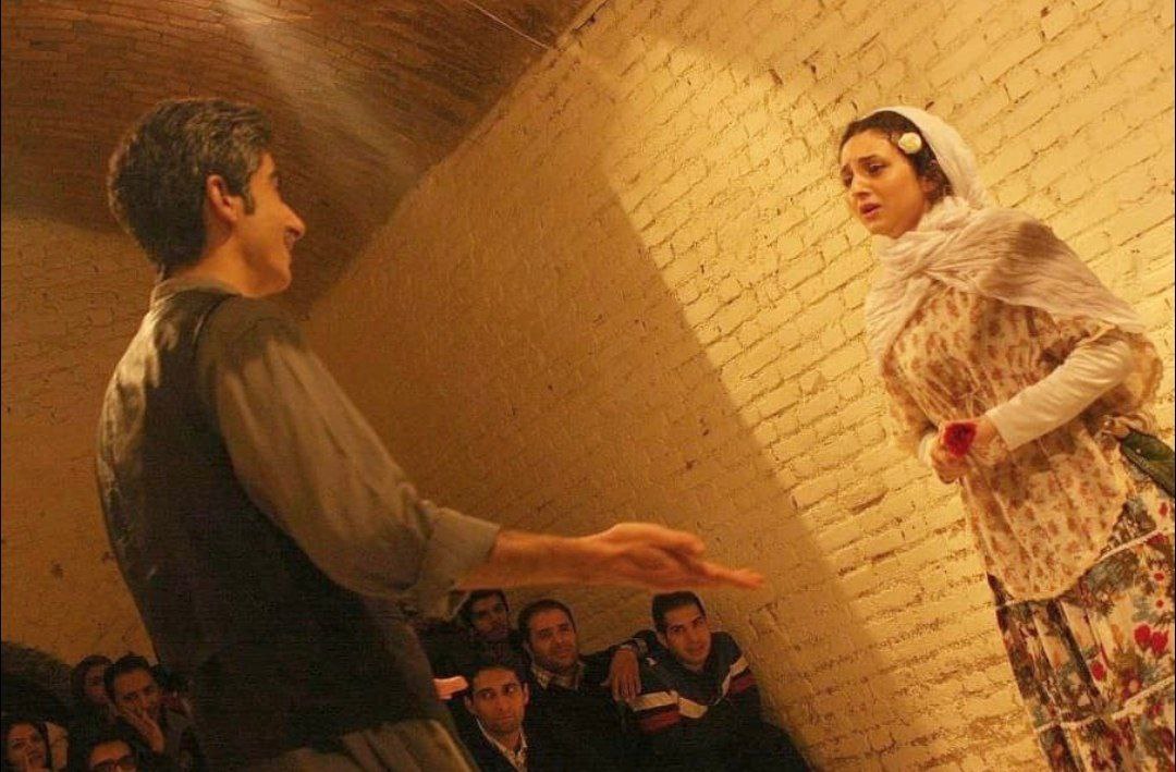 Actors performing against a textured wall